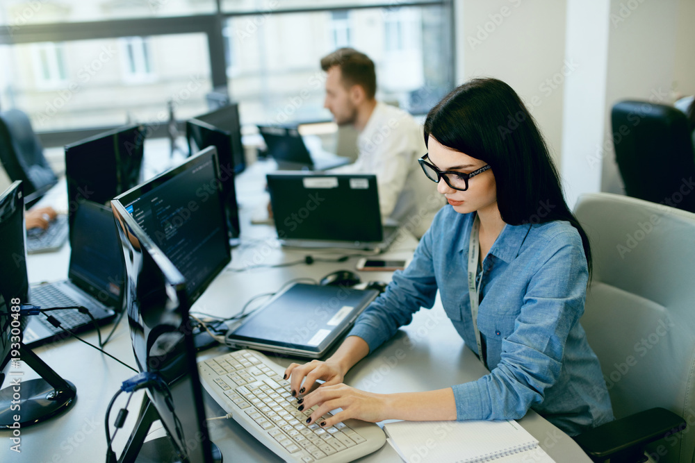Young Woman Working And Programming On Computer In Office. Young Woman Working And Programming On Computer In Office.