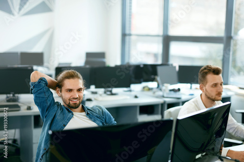 Programmers Working, Looking At Computer In IT Office.