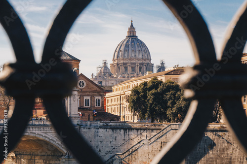 Basilica St. Peter in Vatican as seen from Sant' Angelo Bridge in Rome, Italy. Focus on the Basilica