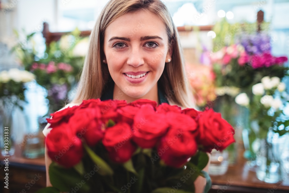 Female florist holding bunch of rose flowers Female florist holding bunch of rose flowers