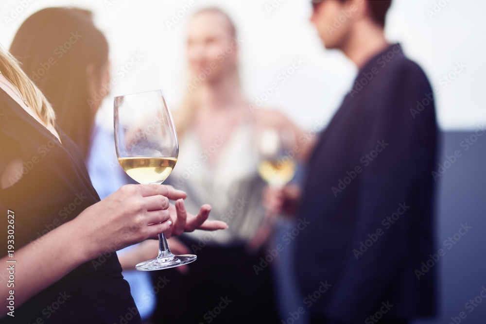 Close up of a wineglass in hands of a nice young woman Close up of a wineglass in hands of a nice young woman