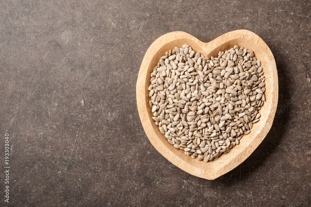 Sunflower seeds in heart shaped bowl Sunflower seeds in heart shaped bowl