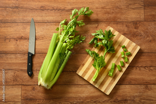 celery cut with knife and chopping board