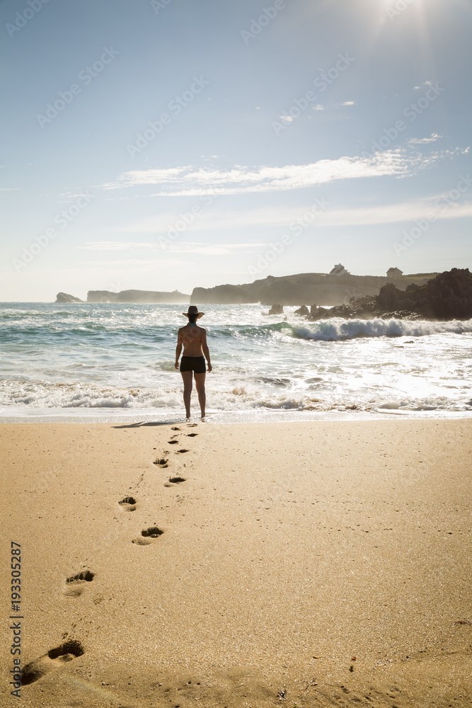 woman walking through the sand of a lonely and beautiful beach
woman walking through the sand of a lonely and beautiful beach