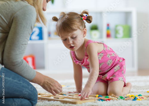 Kid girl playing with devel...