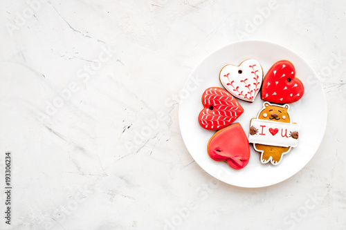 Sweet gift for St Valentine's Day. Heart shaped gingerbread on light grey background top view copy space