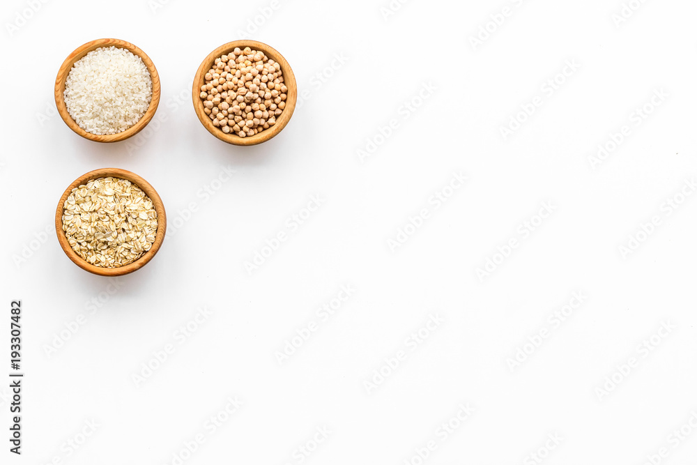 Fototapeta premium Healthy breakfast. Various cereals in bowls on white background top view copy space