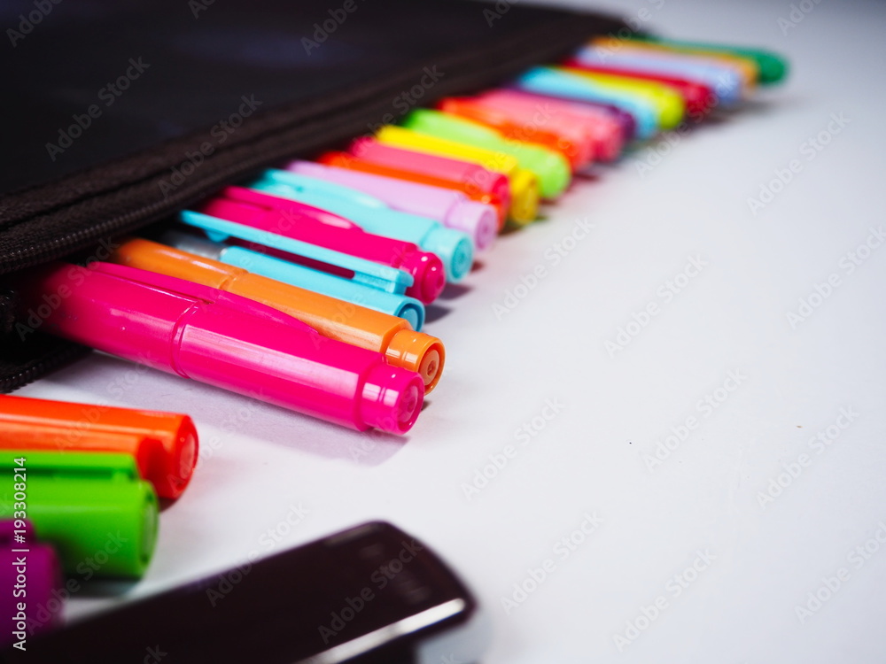 Fototapeta premium Close up Multi colored pens in pencil bag on a white background.