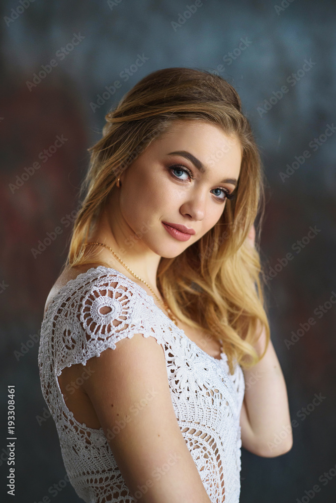 Close up portrait of attractive blond girl in white knitted sweater Close up portrait of attractive blond girl in white knitted sweater