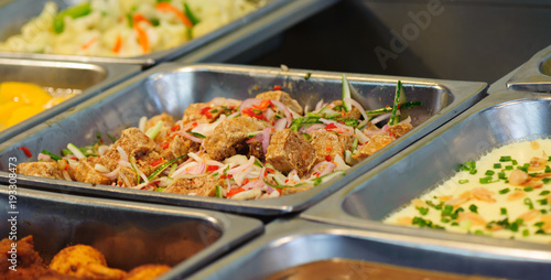 Steel tray filled with food inside the self service Chinese restaurant