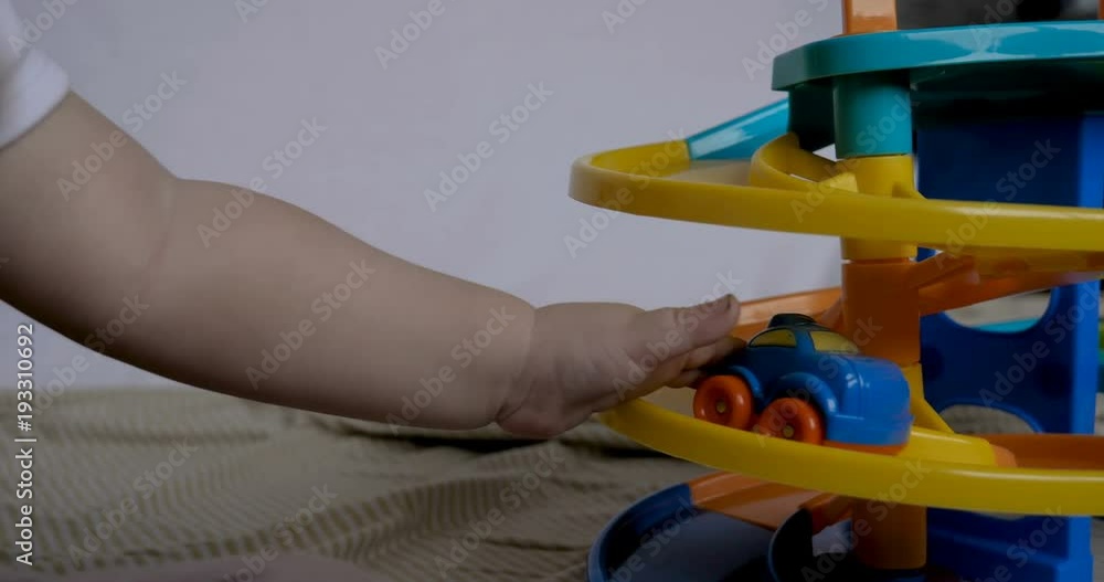 Little baby (boy), sits playing toy cars, white background. Concept: babies, fair skin, beautiful children. Little baby (boy), sits playing toy cars, white background. Concept: babies, fair skin, beautiful children.