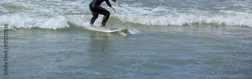 riding wave on surf board in ocean