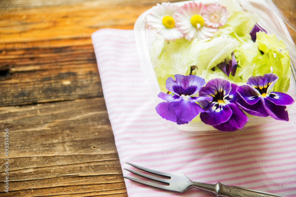 Spring salad with radishes, edible flower and sauce, selective focus Spring salad with radishes, edible flower and sauce, selective focus