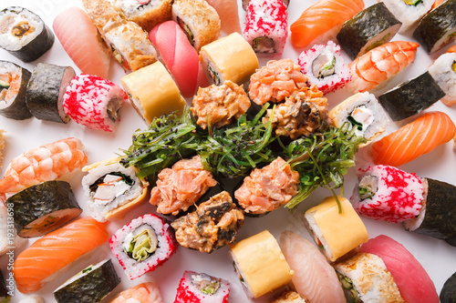 Set of sushi, maki and rolls on white