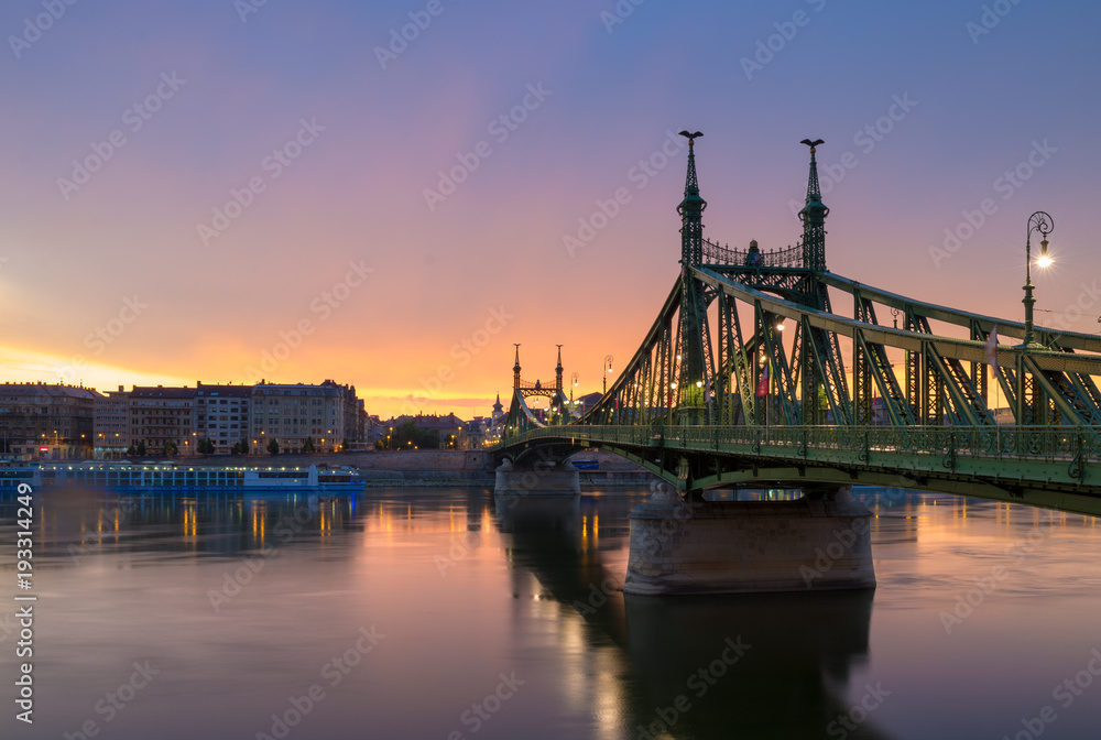Liberty bridge, still Danube river in morning glow, Budapest