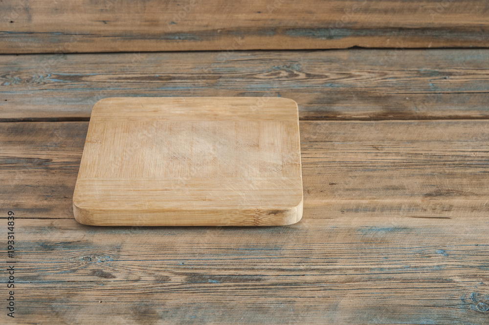 Wood chopping board on wooden background