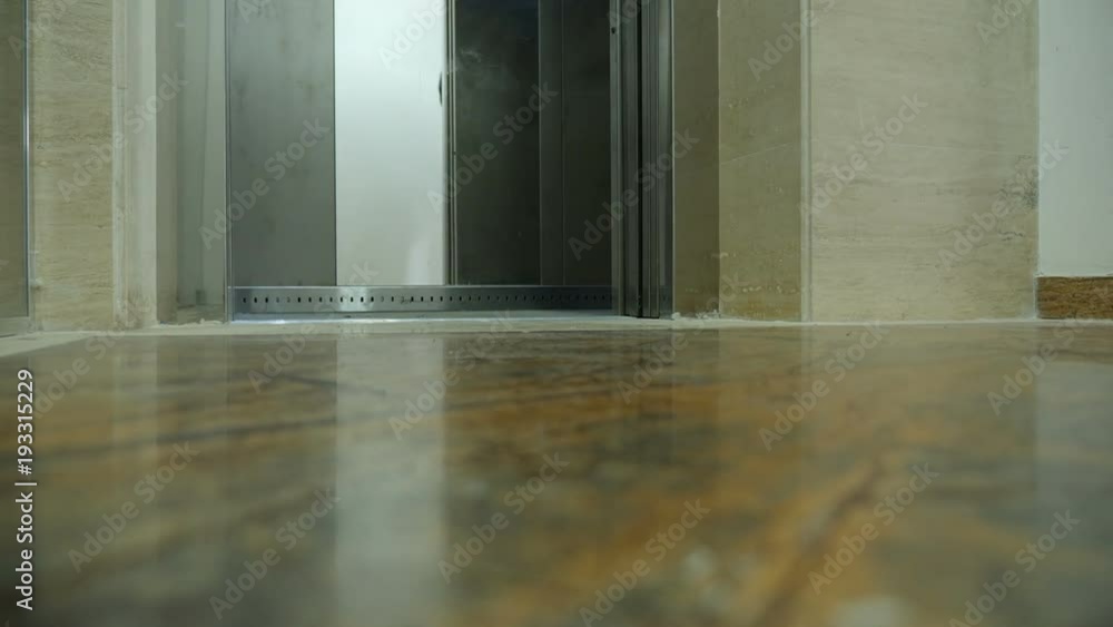 Man feet leaving the elevator. Unrecognisable person Man feet leaving the elevator. Unrecognisable person