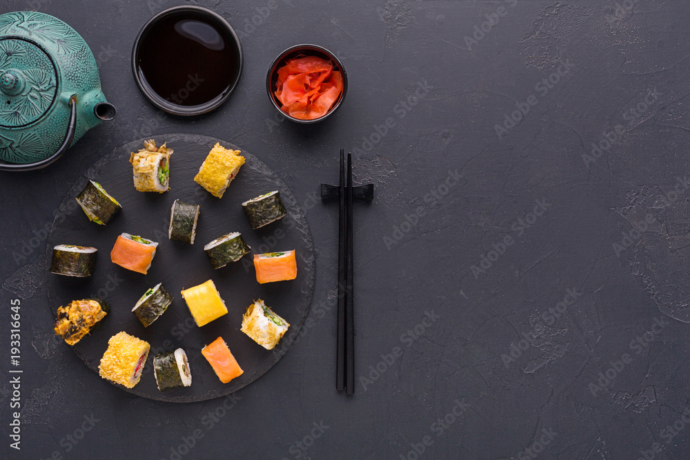 Set of sushi maki and rolls on gray background, top view
