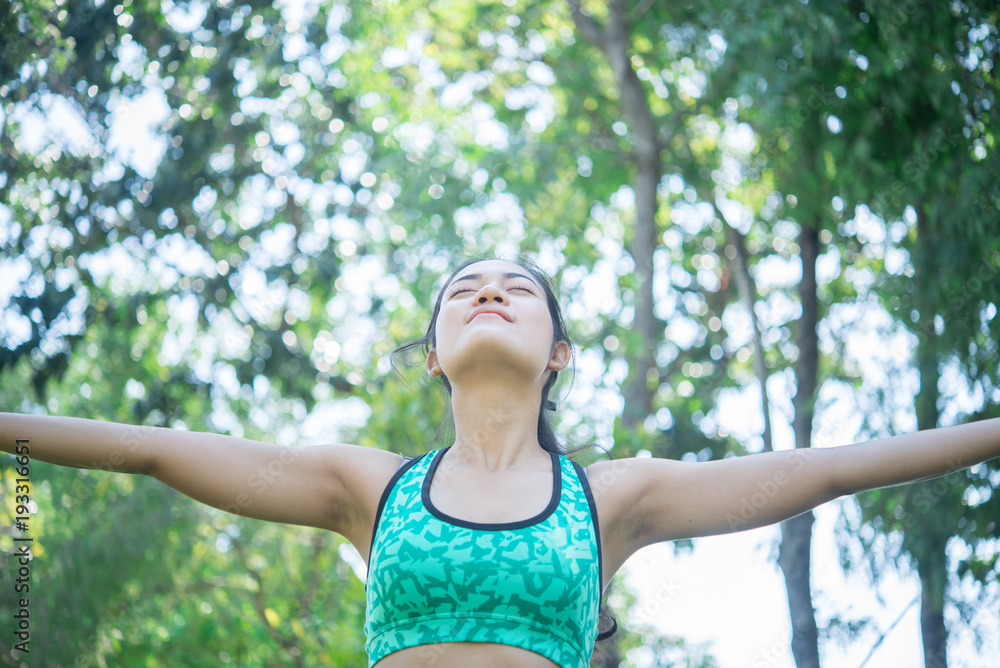 Asian sporty woman stretching arms breathing fresh air at mountain with beautiful sky,Thailand people Asian sporty woman stretching arms breathing fresh air at mountain with beautiful sky,Thailand people