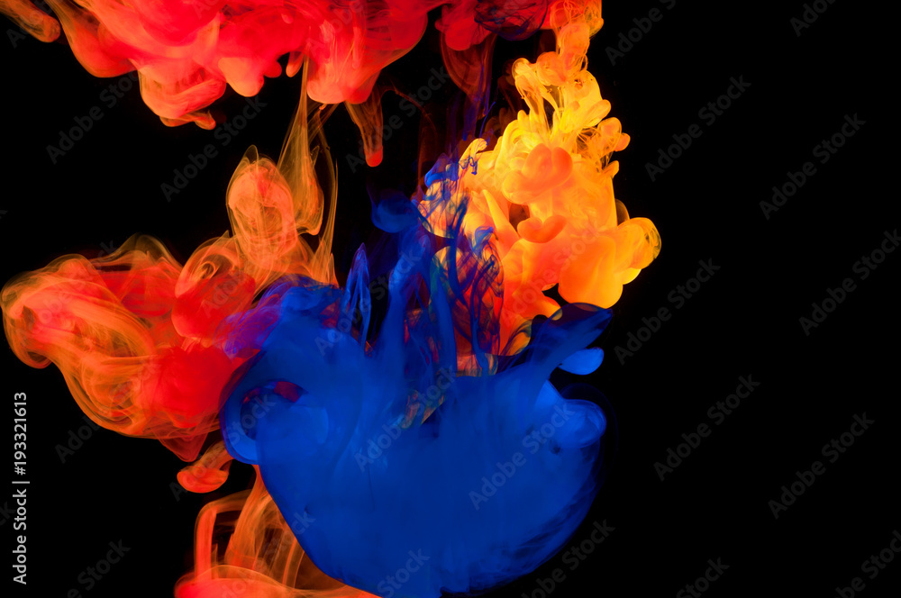 Abstraction of multicolored paints in water on a black background