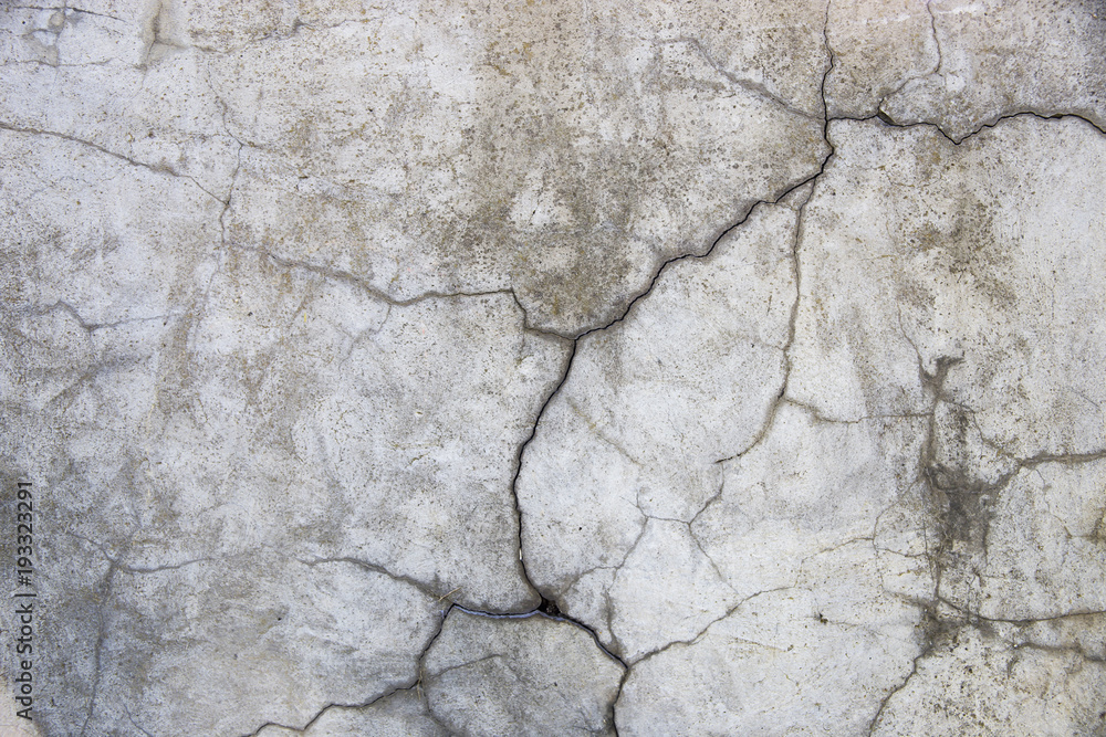 Concrete wall with cracks. Gray urban background. Space for text Concrete wall with cracks. Gray urban background. Space for text