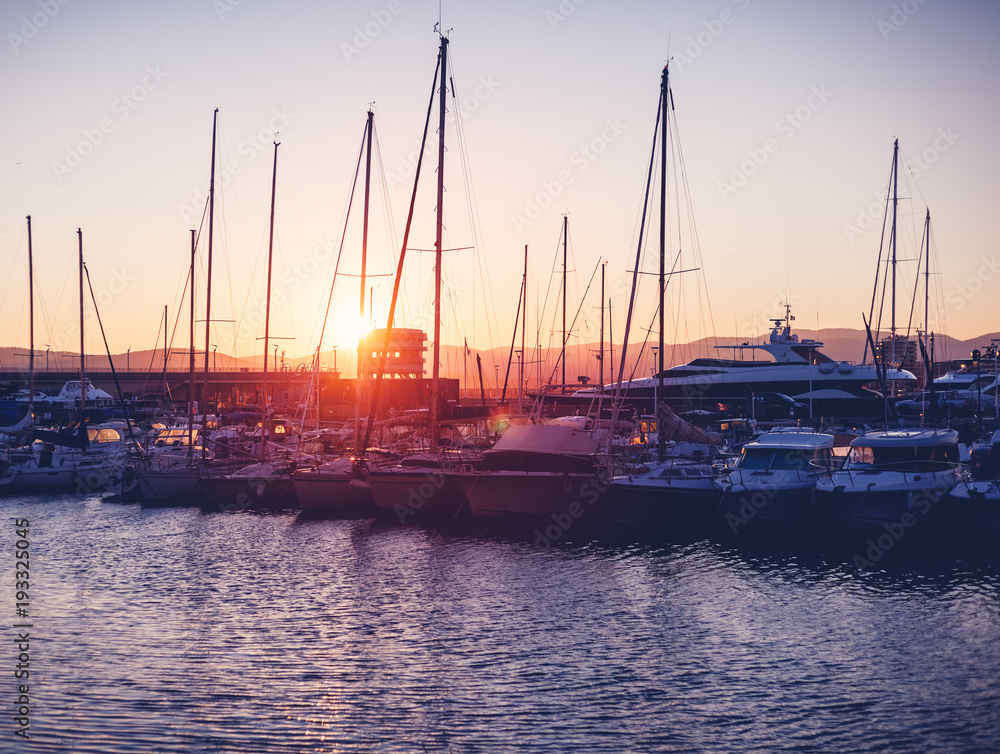 dock with white boats and yachts on a beautiful colorful sunset on the Cote d'Azur, France