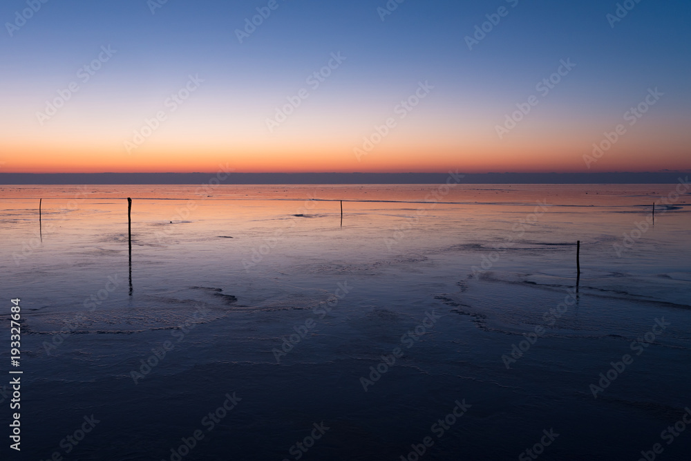 Before sunrise on frozen lake.