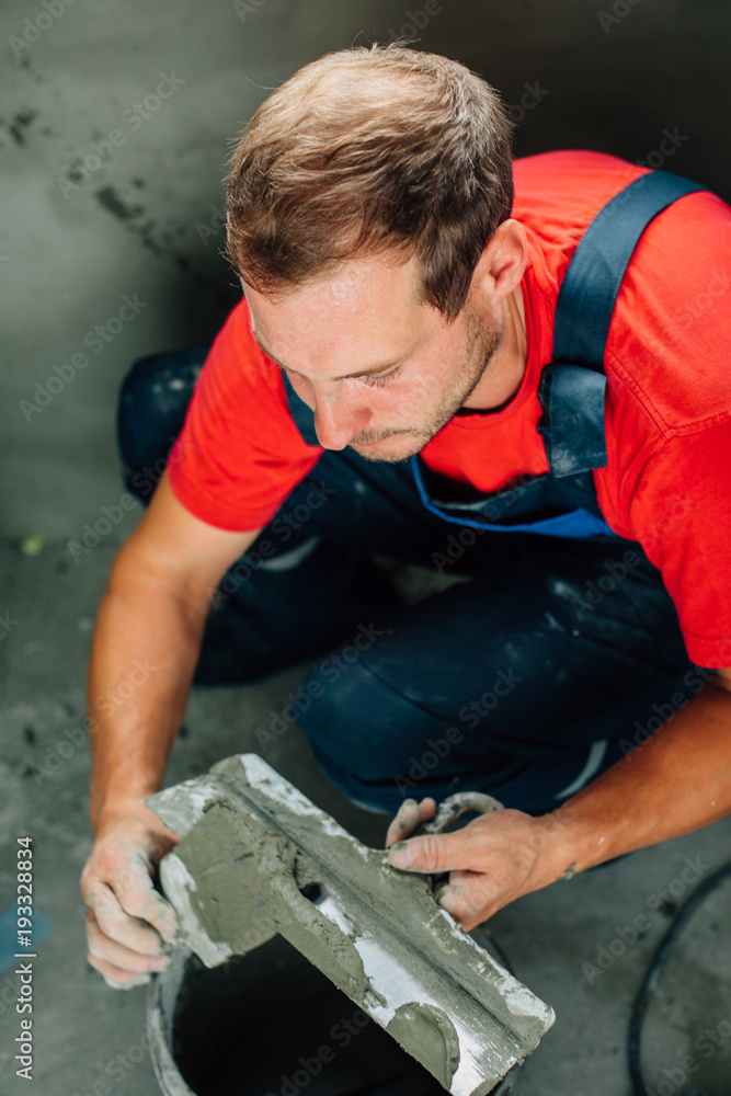 close up plasterer concrete worker at wall close up plasterer concrete worker at wall