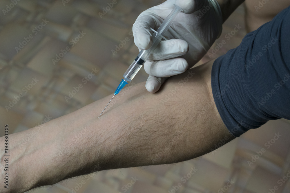 injection of a syringe into a vein injection of a syringe into a vein