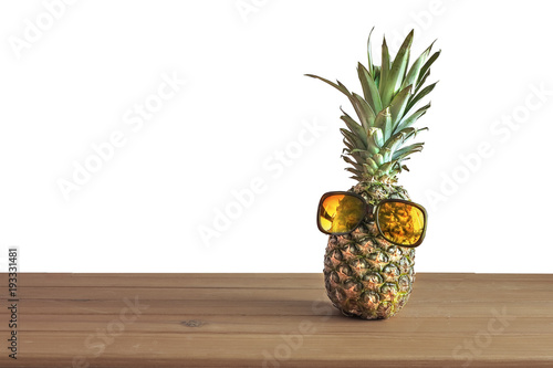  pineapple in glasses on a wooden background isolated