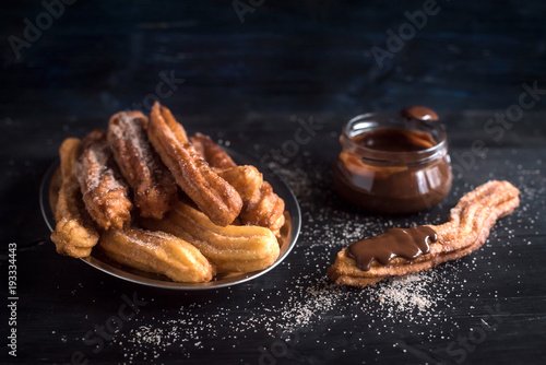 Sweet homemame churros with chocolate,selective focus