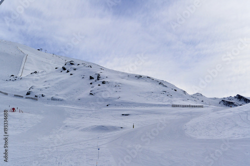 Snowy landscape of  Sierra Nevada with blue sky,  chairlift  and white mountains with snow..