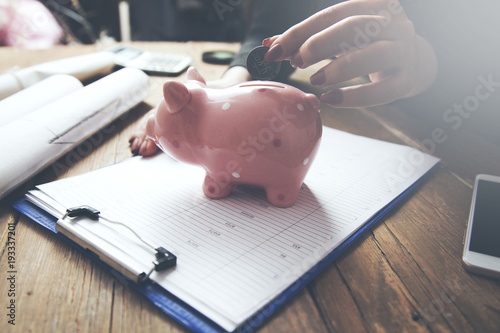 woman hand piggy bank and document