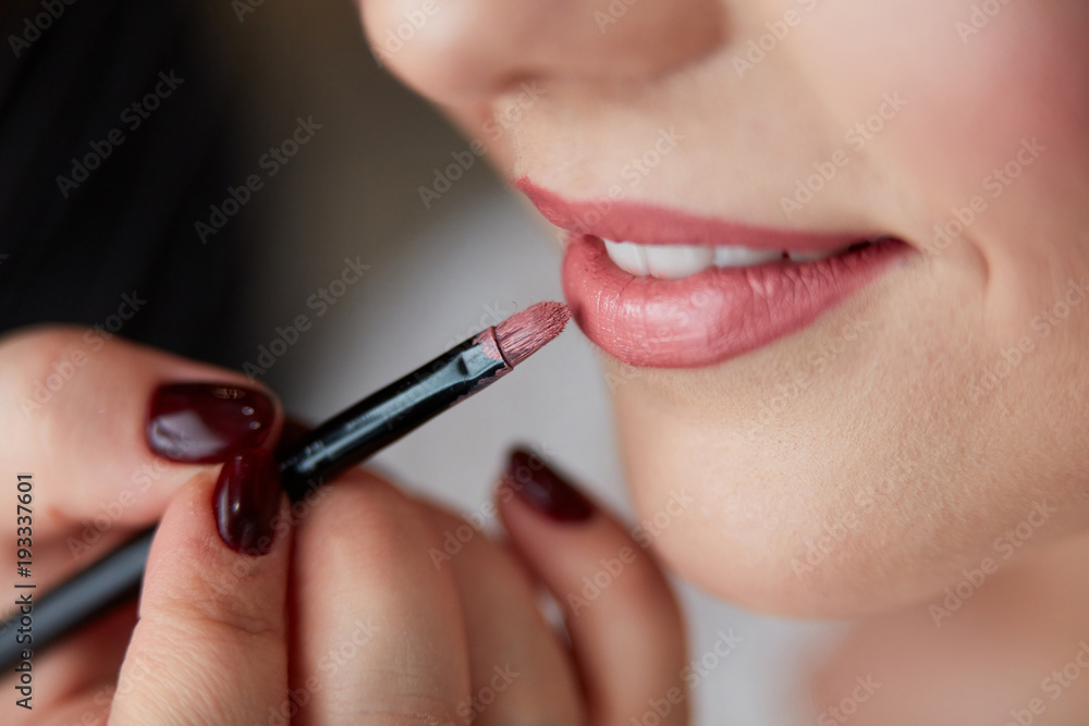 Lipstick is being applied to lips