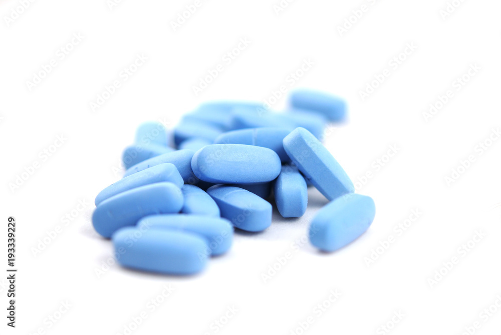 Big blue oval tablets closeup on white background Big blue oval tablets closeup on white background