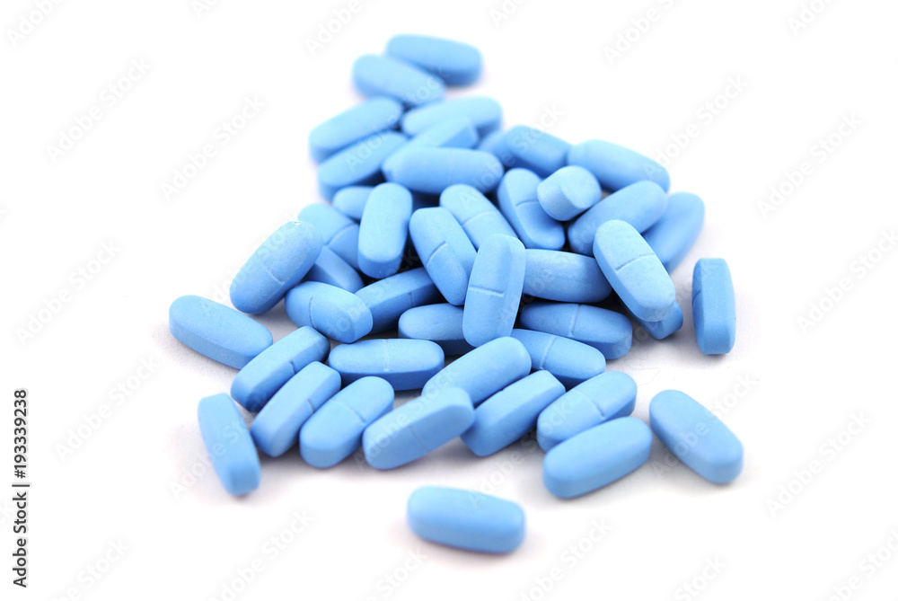 Big blue oval tablets closeup on white background Big blue oval tablets closeup on white background