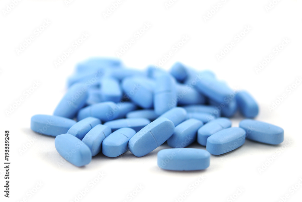 Big blue oval tablets closeup on white background Big blue oval tablets closeup on white background