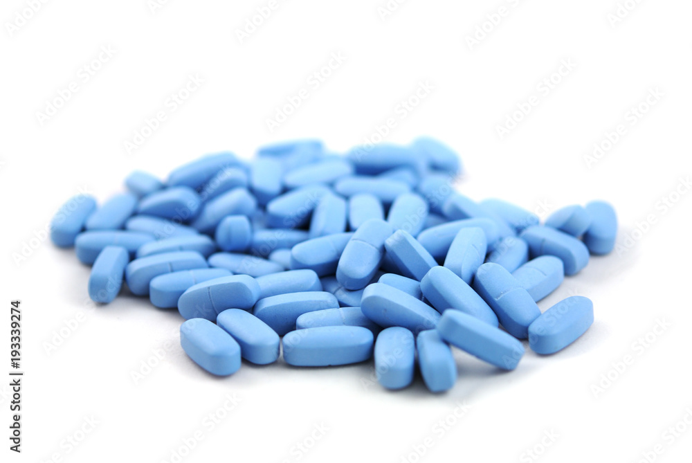 Big blue oval tablets closeup on white background Big blue oval tablets closeup on white background