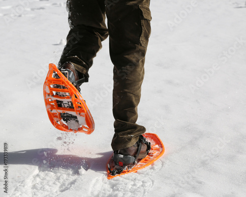Man with corduroy trousers with snowshoes