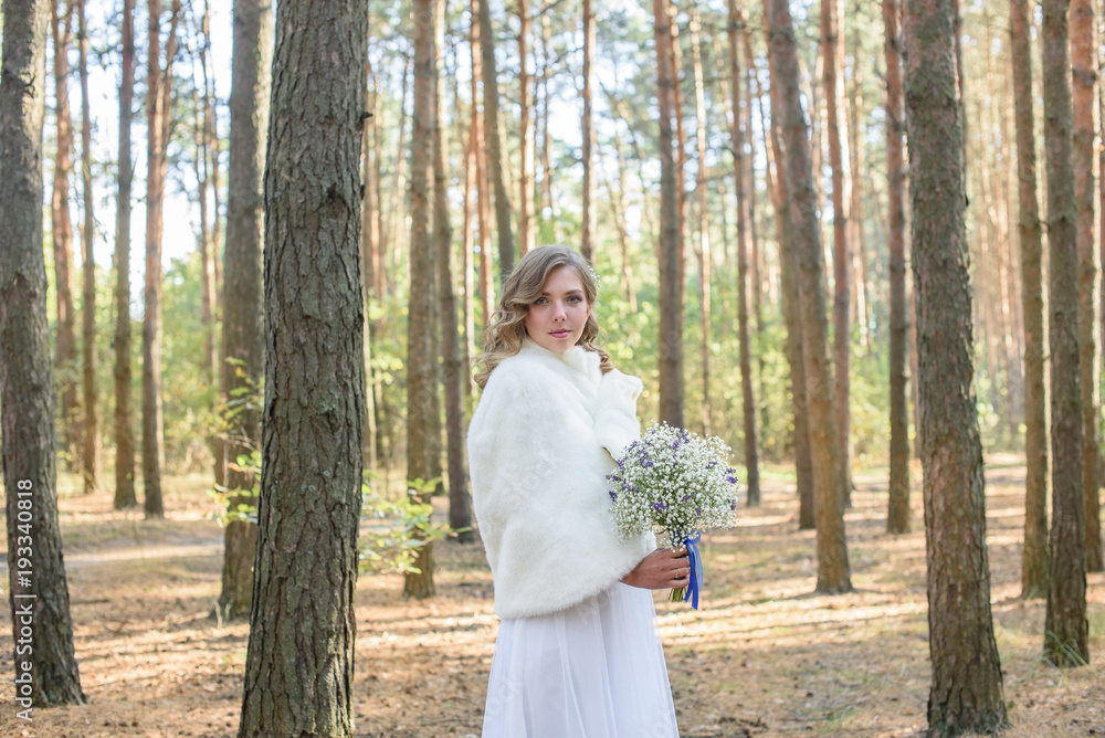 Portrait of a woman in wedding dress with white flowers. the bride holding a bouquet Portrait of a woman in wedding dress with white flowers. the bride holding a bouquet