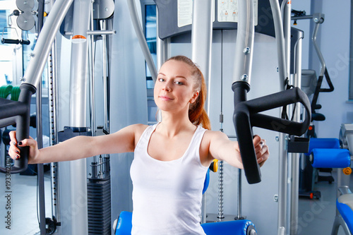 Group of people at the gym exercising on cross trainers. people at the gym photo