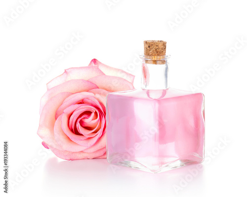 Pink rose and glass bottle with transparent liquid