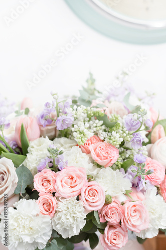 flower shop concept. Close-up beautiful luxury bouquet of mixed flowers on wooden table. Wallpaper