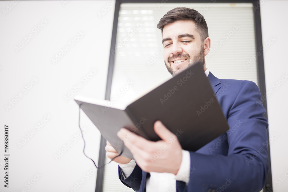 businessman in suit in meeting room reading notes businessman in suit in meeting room reading notes