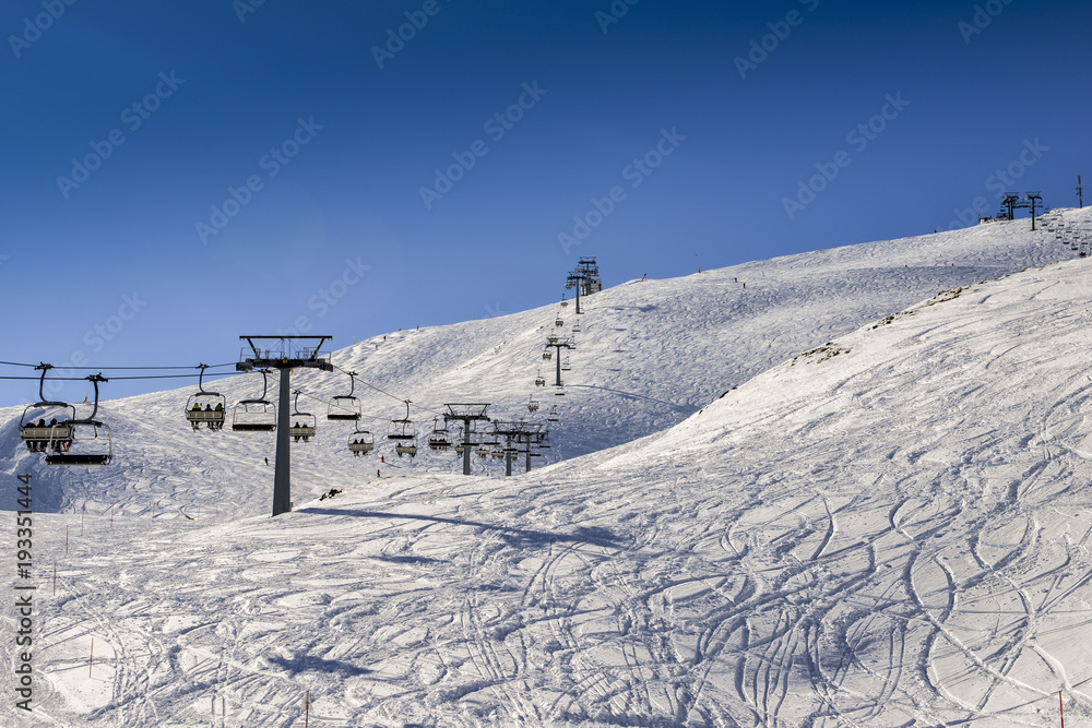 Chairlift at Italian ski area on snow covered Alps during the winter