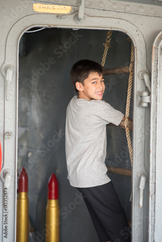 Boy  driving war ship military at the national museam photo