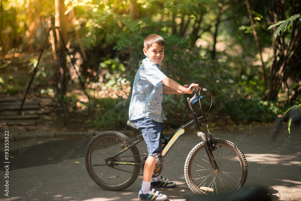 Little boy riding a bike in the park