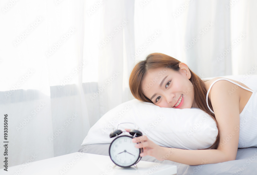 Beautiful asian young woman turn off alarm clock in morning, wake up for sleep with alarm clock, relax and lifestyle concept. Beautiful asian young woman turn off alarm clock in morning, wake up for sleep with alarm clock, relax and lifestyle concept.