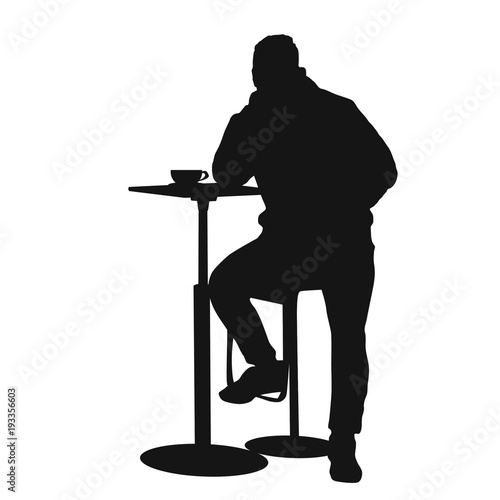 Man silhouette sitting at a table in the cafe, bar, restaurant or pub