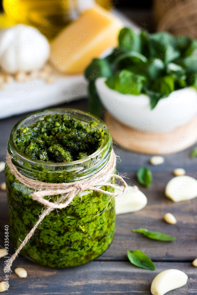 Fresh homemade pesto sauce and ingredients to it Fresh homemade pesto sauce and ingredients to it